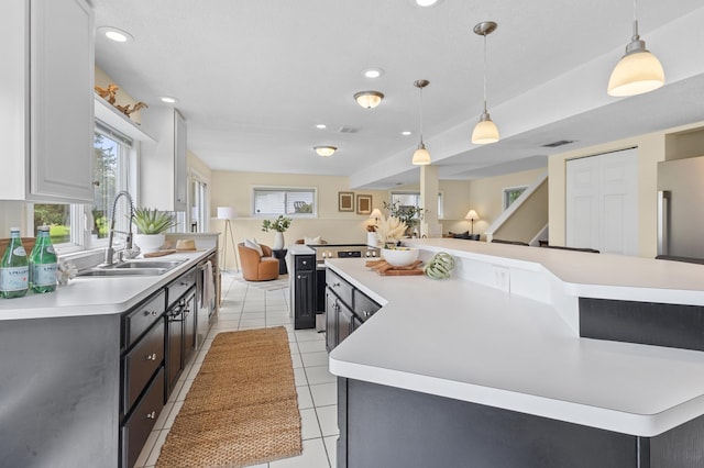 12329 Timber Ln, Maple Grove, MN 55369 - kitchen featuring light countertops, light tile patterned floors, healthy amount of natural light, high end fridge, and recessed lighting