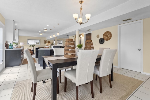 12329 Timber Ln, Maple Grove, MN 55369 - dining space featuring light tile patterned floors and a chandelier