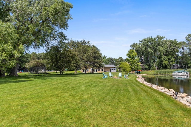 12329 Timber Ln, Maple Grove, MN 55369 - view of grassy yard with a trampoline and a water view