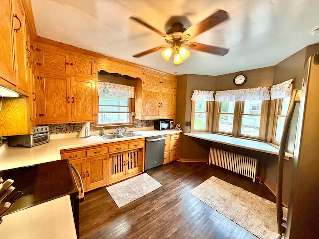 215 1st St N, Cannon Falls, MN 55009 - kitchen with stainless steel dishwasher, radiator heating unit, light countertops, electric range, and decorative backsplash