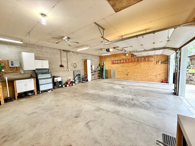 215 1st St N, Cannon Falls, MN 55009 - garage with concrete block wall, a garage door opener, and ceiling fan