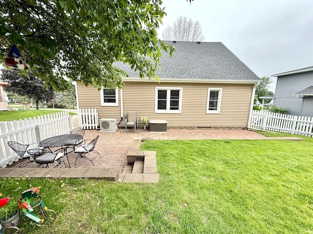 215 1st St N, Cannon Falls, MN 55009 - rear view of property with a patio area, a shingled roof, and a fenced backyard
