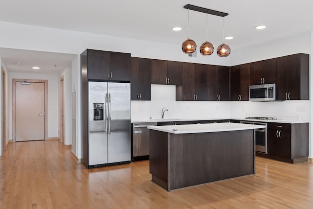 1240 2nd St Unit 1024, Minneapolis, MN 55415 - kitchen with appliances with stainless steel finishes, light countertops, light wood-style floors, dark brown cabinetry, and recessed lighting