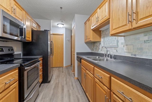 10787 Unity Ln N, Brooklyn Park, MN 55443 - kitchen featuring stainless steel appliances, light wood finished floors, dark countertops, backsplash, and a textured ceiling