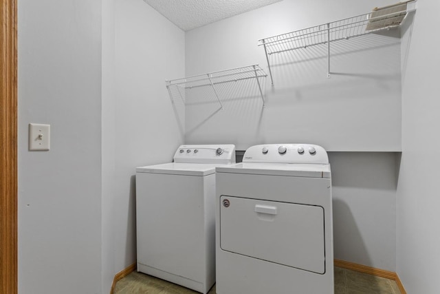 10787 Unity Ln N, Brooklyn Park, MN 55443 - laundry room featuring washing machine and dryer and a textured ceiling