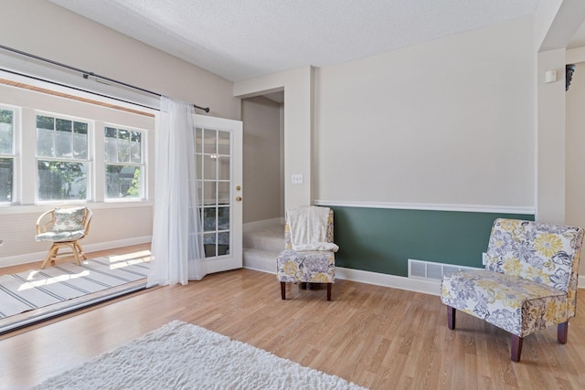 721 Smith Ave S, Saint Paul, MN 55107 - living area featuring wood finished floors and a textured ceiling