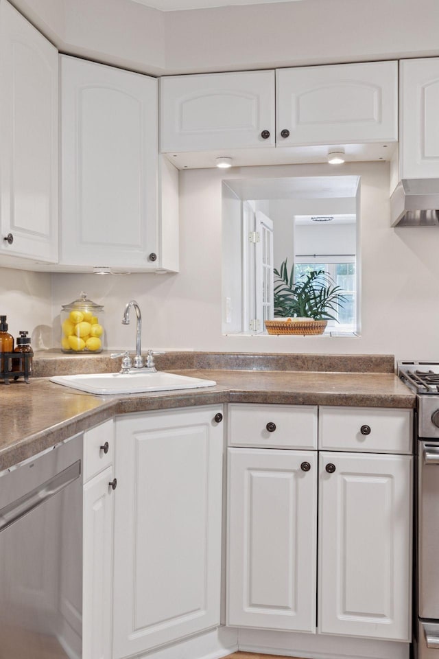 721 Smith Ave S, Saint Paul, MN 55107 - kitchen featuring appliances with stainless steel finishes, white cabinetry, and wall chimney exhaust hood