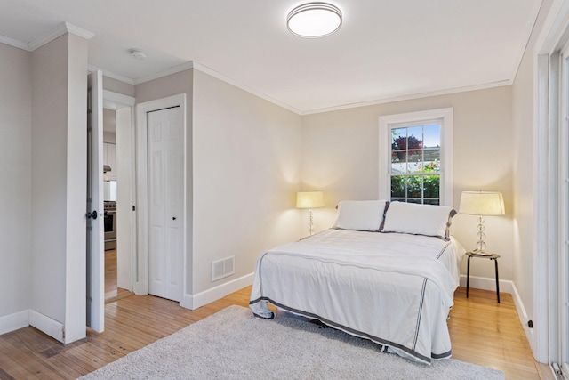 721 Smith Ave S, Saint Paul, MN 55107 - bedroom featuring light wood-style floors and ornamental molding