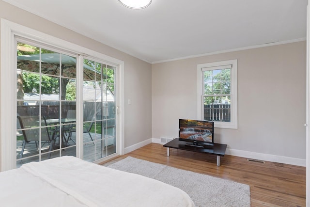721 Smith Ave S, Saint Paul, MN 55107 - bedroom featuring access to outside, wood finished floors, and crown molding