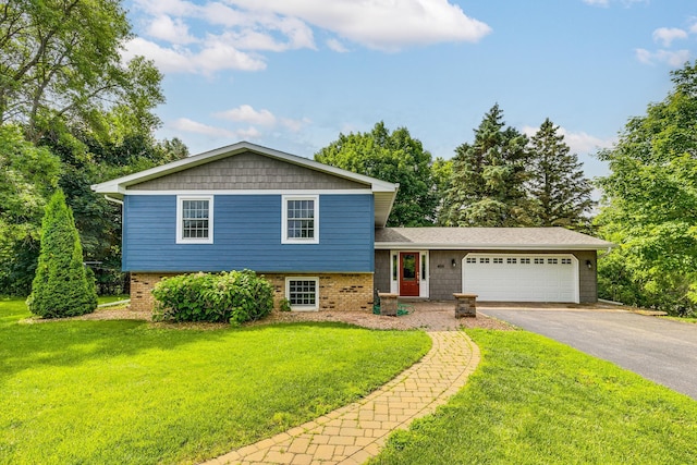 989 Kadler Ave NE, Saint Michael, MN 55376 - split level home featuring an attached garage, driveway, a front yard, and brick siding
