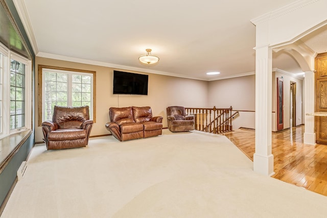 989 Kadler Ave NE, Saint Michael, MN 55376 - living area with crown molding, ornate columns, light wood finished floors, and light colored carpet