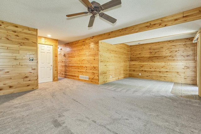 989 Kadler Ave NE, Saint Michael, MN 55376 - spare room featuring wood walls, carpet flooring, ceiling fan, and a textured ceiling