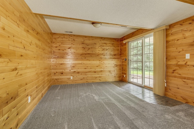 989 Kadler Ave NE, Saint Michael, MN 55376 - spare room featuring a textured ceiling, wooden walls, and tile patterned floors