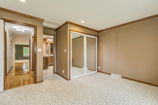 989 Kadler Ave NE, Saint Michael, MN 55376 - unfurnished bedroom featuring crown molding, a closet, light colored carpet, and recessed lighting