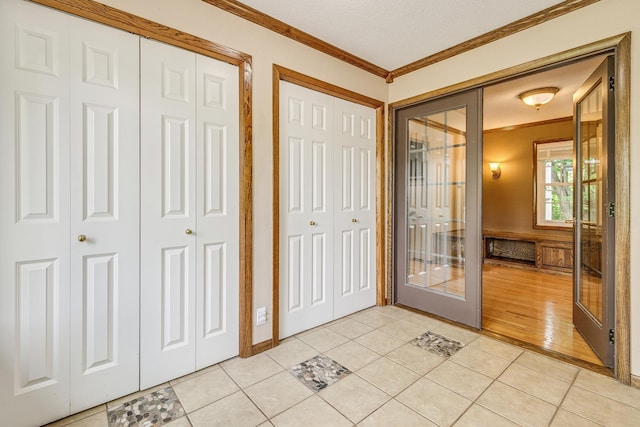 989 Kadler Ave NE, Saint Michael, MN 55376 - foyer entrance featuring crown molding, light tile patterned flooring, and french doors