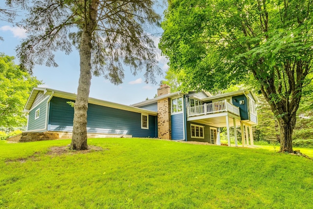 989 Kadler Ave NE, Saint Michael, MN 55376 - rear view of property with a chimney, a lawn, and a deck