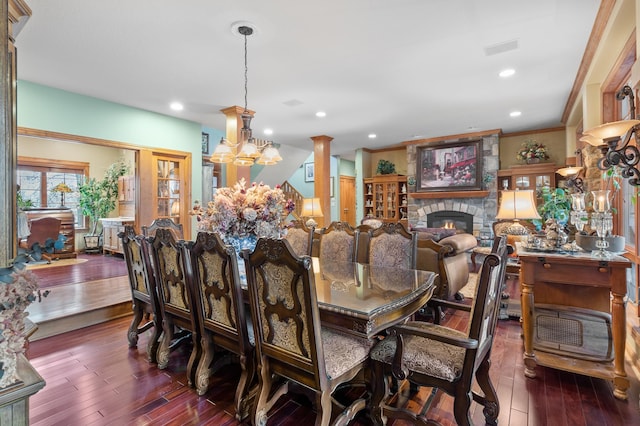 12322 Coffee Trl, Rosemount, MN 55068 - dining space featuring hardwood / wood-style floors, a fireplace, a chandelier, recessed lighting, and crown molding