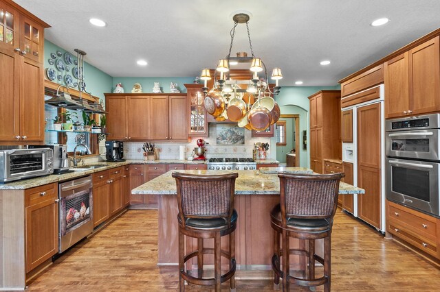 12322 Coffee Trl, Rosemount, MN 55068 - kitchen featuring dishwashing machine, high quality fridge, double oven, a center island, and glass insert cabinets