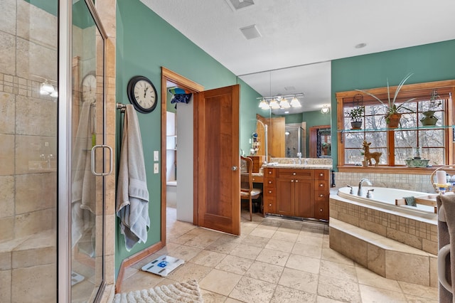 12322 Coffee Trl, Rosemount, MN 55068 - full bath featuring vanity, a bath, a stall shower, and stone tile floors
