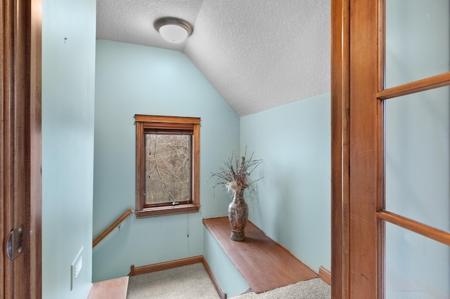 12322 Coffee Trl, Rosemount, MN 55068 - stairs featuring a textured ceiling, vaulted ceiling, and carpet flooring