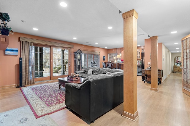 12322 Coffee Trl, Rosemount, MN 55068 - living room with ornate columns, light wood-style floors, and recessed lighting