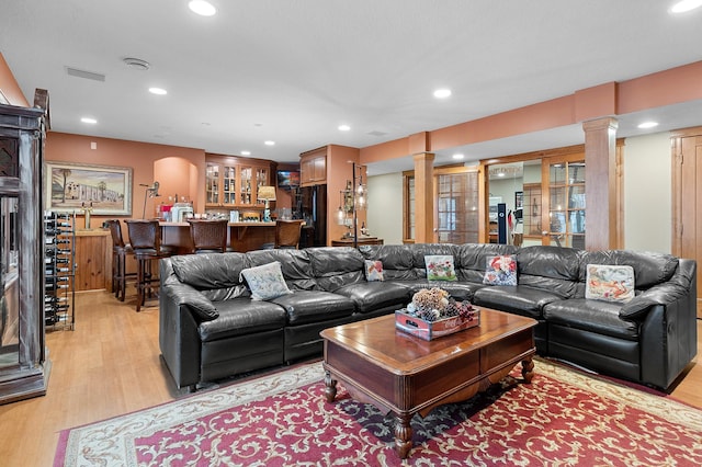 12322 Coffee Trl, Rosemount, MN 55068 - living room featuring ornate columns, light wood-style floors, bar area, and recessed lighting