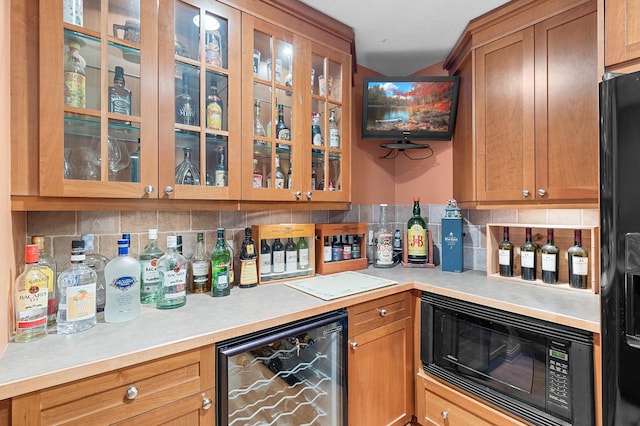 12322 Coffee Trl, Rosemount, MN 55068 - indoor dry bar with beverage cooler, black appliances, and backsplash