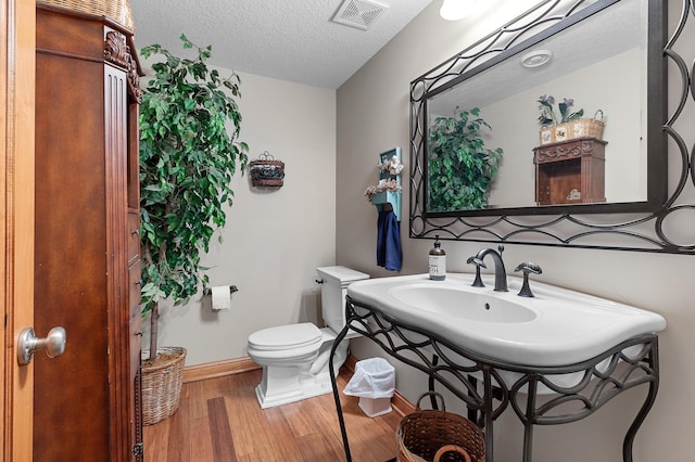 12322 Coffee Trl, Rosemount, MN 55068 - half bath with wood finished floors, a textured ceiling, and vanity