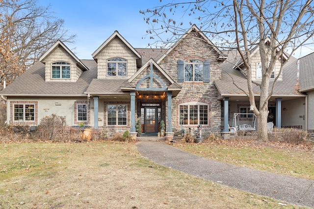 12322 Coffee Trl, Rosemount, MN 55068 - view of front of house featuring a porch, a shingled roof, a front yard, and stone siding