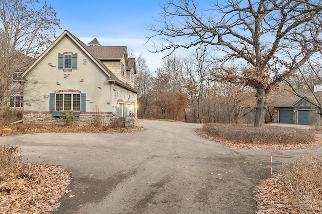 12322 Coffee Trl, Rosemount, MN 55068 - view of property exterior featuring asphalt driveway, a shingled roof, and stucco siding