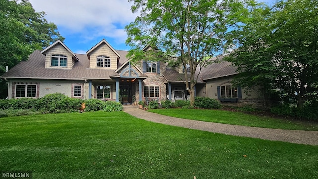 12322 Coffee Trl, Rosemount, MN 55068 - view of front of house featuring a front yard, stone siding, and roof with shingles