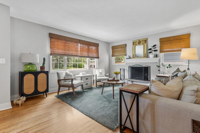 4633 Ewing Ave N, Robbinsdale, MN 55422 - living room featuring wood finished floors and a brick fireplace