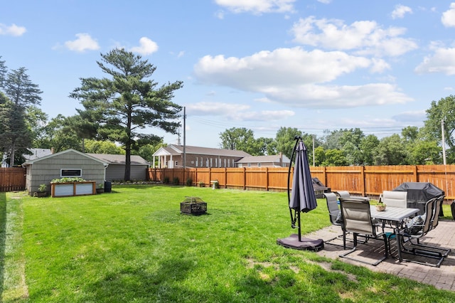 4633 Ewing Ave N, Robbinsdale, MN 55422 - fenced backyard featuring an outdoor fire pit, a patio, and an outdoor structure