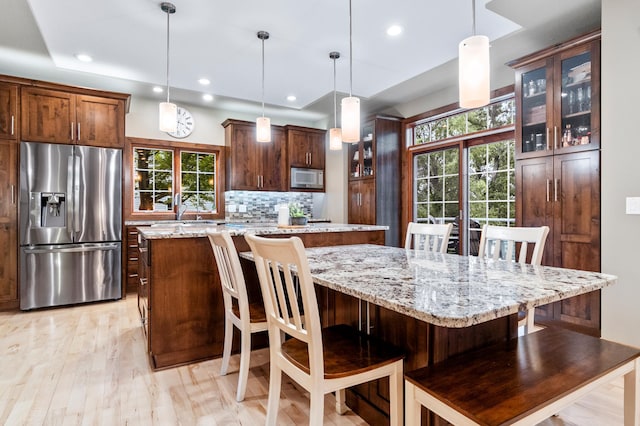 4326 Donway Dr NE, Alexandria, MN 56308 - kitchen featuring stainless steel fridge, white microwave, a kitchen island, healthy amount of natural light, and recessed lighting