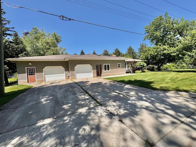 300 Lyon St, Minneota, MN 56264 - ranch-style house featuring concrete driveway, a front lawn, and an attached garage