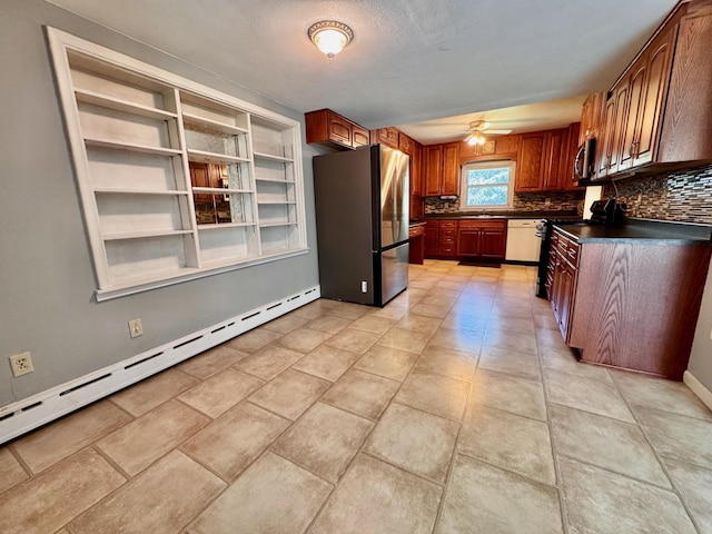300 Lyon St, Minneota, MN 56264 - kitchen featuring stainless steel appliances, a baseboard radiator, dark countertops, a ceiling fan, and decorative backsplash