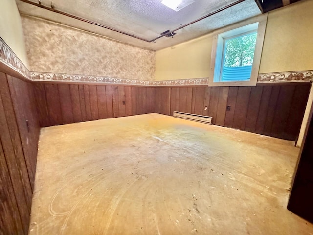 300 Lyon St, Minneota, MN 56264 - unfurnished room with wainscoting, baseboard heating, and wooden walls