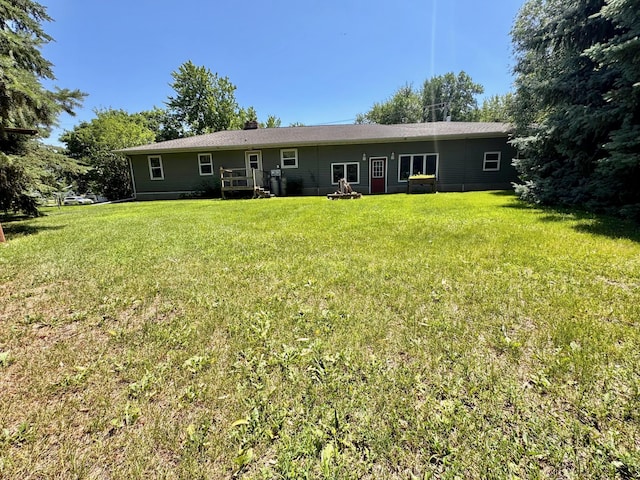 300 Lyon St, Minneota, MN 56264 - rear view of house with a lawn and a deck