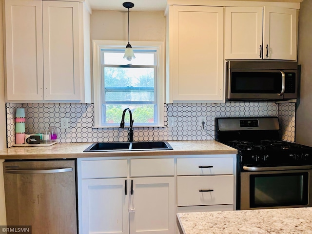 10701 6th St NE, Blaine, MN 55434 - kitchen with stainless steel appliances, white cabinetry, and tasteful backsplash