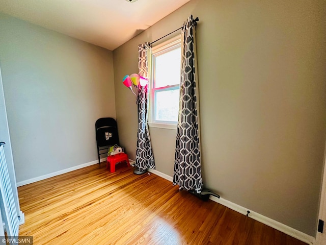 10701 6th St NE, Blaine, MN 55434 - spare room featuring wood finished floors and baseboards