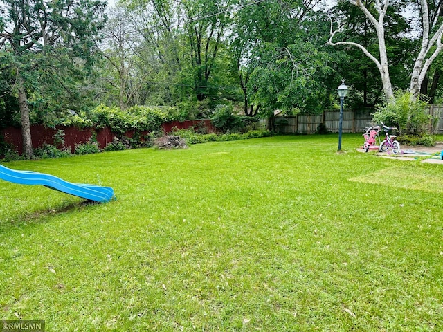10701 6th St NE, Blaine, MN 55434 - fenced backyard featuring a playground