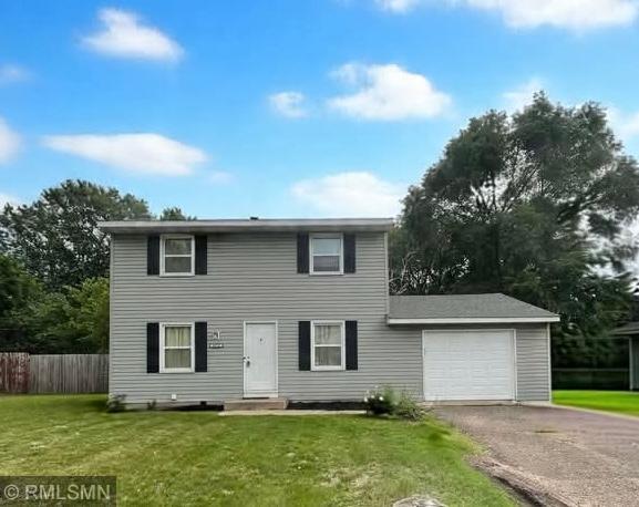 10701 6th St NE, Blaine, MN 55434 - view of front of house featuring driveway and an attached garage