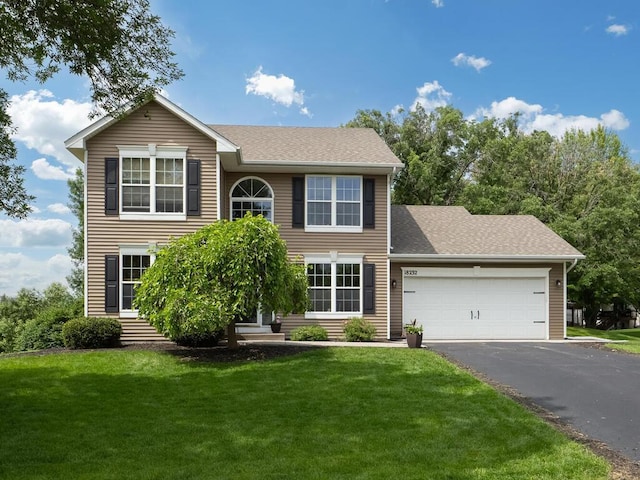 18232 Roosevelt St NW, Elk River, MN 55330 - colonial house with an attached garage, driveway, a front lawn, and roof with shingles