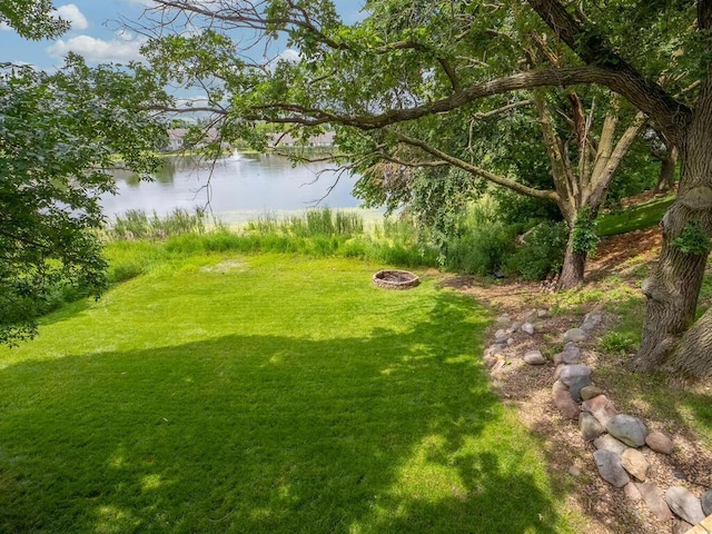 18232 Roosevelt St NW, Elk River, MN 55330 - view of grassy yard with a water view and an outdoor fire pit