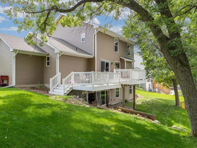 18232 Roosevelt St NW, Elk River, MN 55330 - back of property with a wooden deck, a yard, and a shingled roof