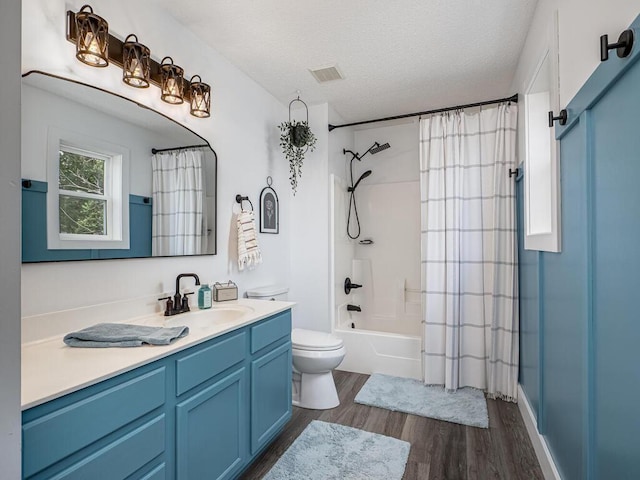 18232 Roosevelt St NW, Elk River, MN 55330 - bathroom featuring vanity, wood finished floors, shower / bathtub combination with curtain, and a textured ceiling