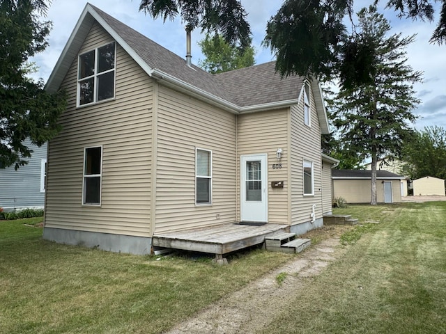 608 Duluth Ave N, Thief River Falls, MN 56701 - rear view of house with a yard and roof with shingles
