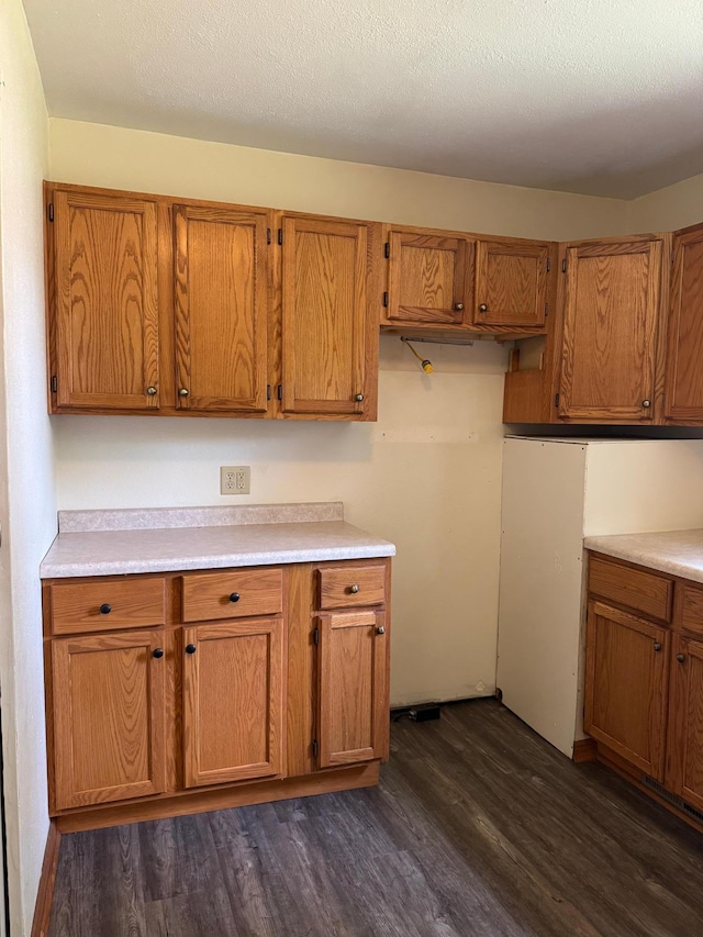 608 Duluth Ave N, Thief River Falls, MN 56701 - kitchen with dark wood-style floors, brown cabinets, and light countertops