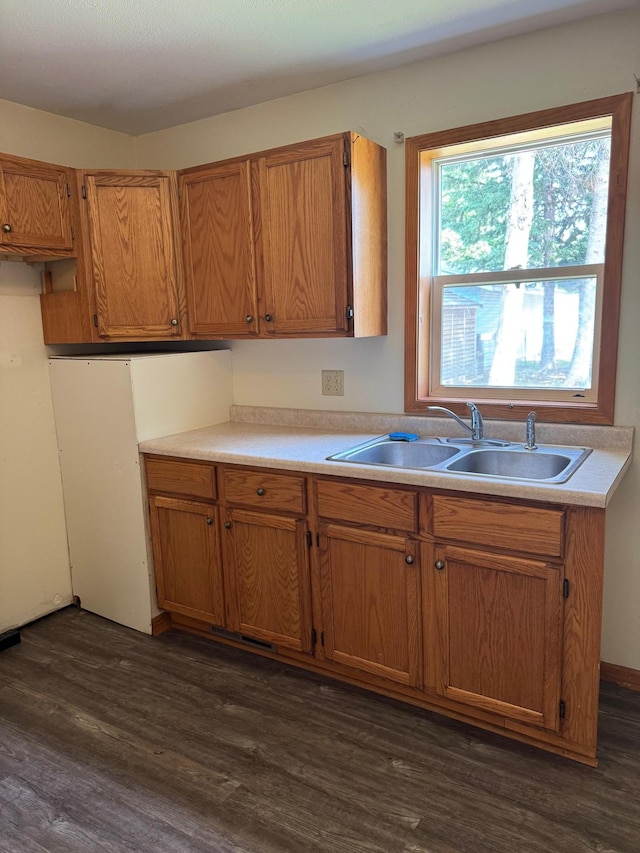 608 Duluth Ave N, Thief River Falls, MN 56701 - kitchen with dark wood-type flooring, light countertops, and brown cabinets