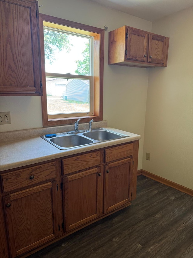 608 Duluth Ave N, Thief River Falls, MN 56701 - kitchen featuring dark wood finished floors, light countertops, and brown cabinets